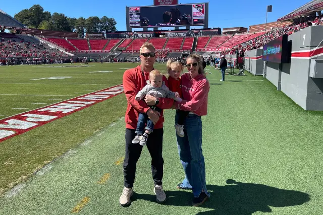 RG Pack Concrete owner Ryan Goodman with his wife and children on the NC State football field in Raleigh, NC