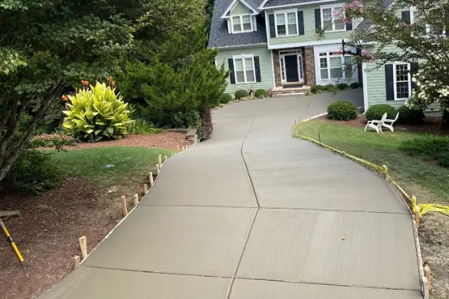 Freshly cured driveway replacement at a green colored home in apex, nc