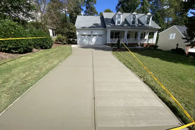 Professional concrete driveway replacement completed by RGPACK CONCRETE in the Kensington at Regency neighborhood on Tattenhall Dr. in Cary, NC.