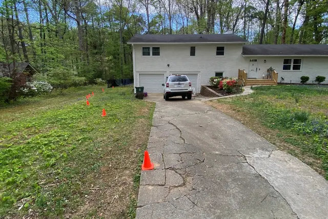 Cracked and deteriorating driveway before replacement in CARY, NC