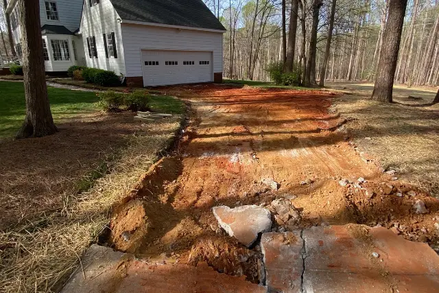 Concrete driveway demolition in Apex, NC, with damaged concrete removed before replacement