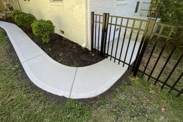 New concrete walkway leading to a residential gate in Cary, NC