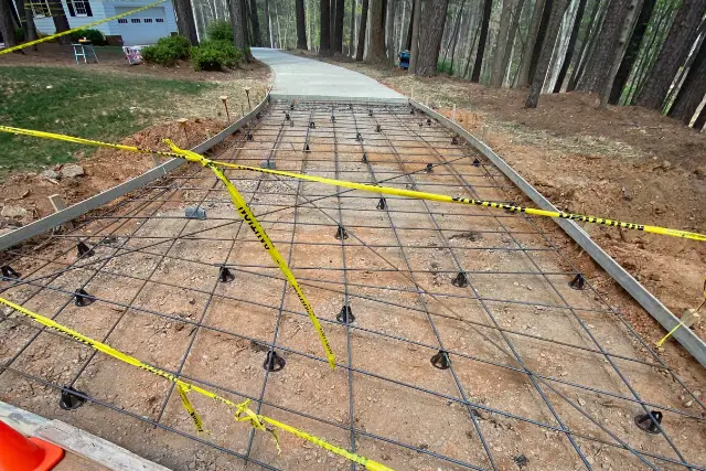 Reinforced concrete driveway installation in Apex, NC with steel rebar grid before pouring
